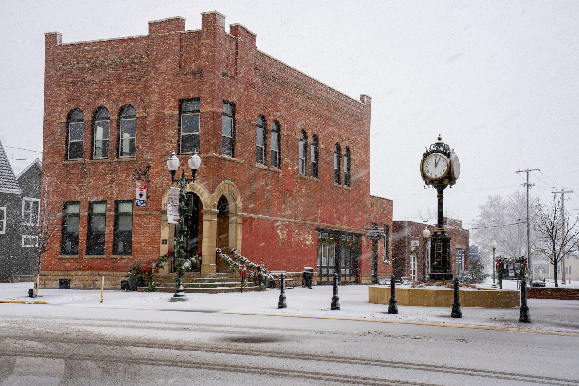 A historic brick building in Wabasha, Minnesota during a winter snowfall, showcasing vintage architecture.