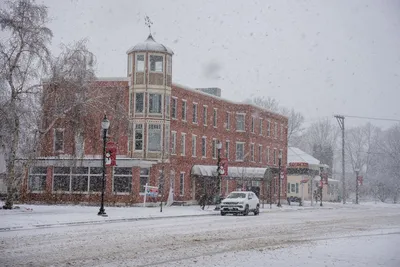 A snowy day in Wabasha, Minnesota, featuring a historic brick building and street view.